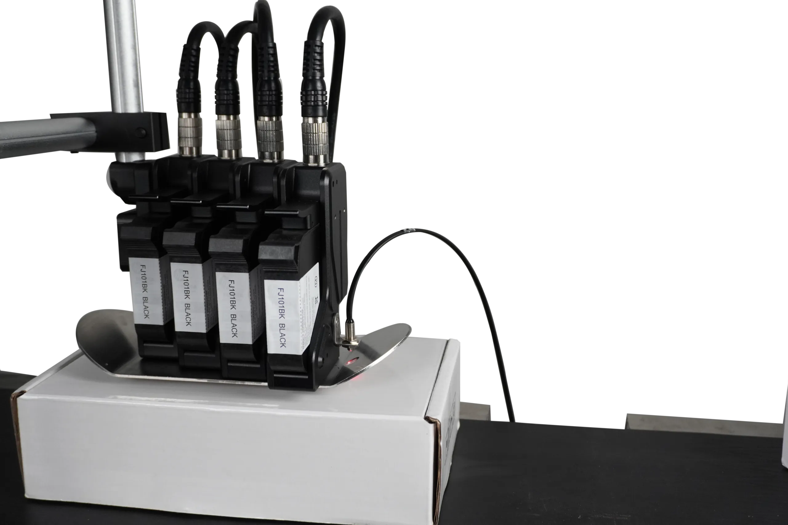 Four-head TIJ assembly mounted above a carton
